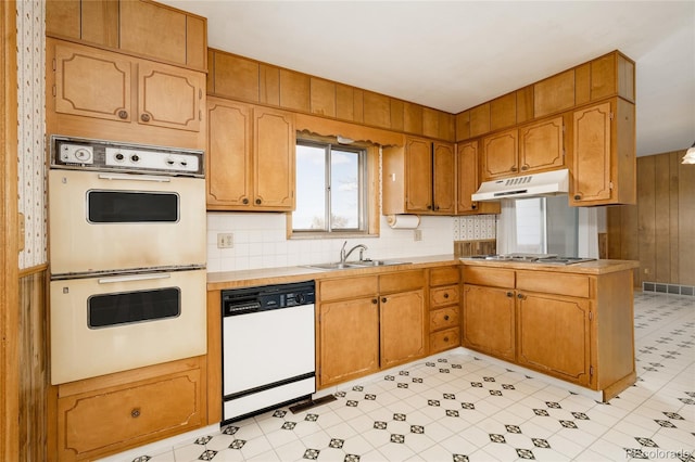 8895 Morton Rd, Niwot, CO 80503 - kitchen featuring white appliances, under cabinet range hood, light countertops, a peninsula, and decorative backsplash