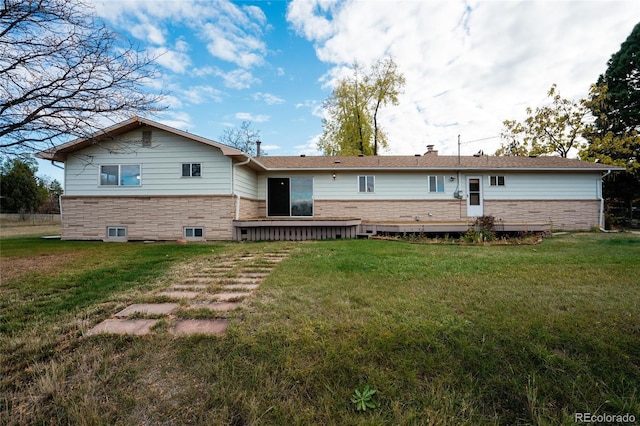 8895 Morton Rd, Niwot, CO 80503 - rear view of property featuring a yard, a wooden deck, and stone siding