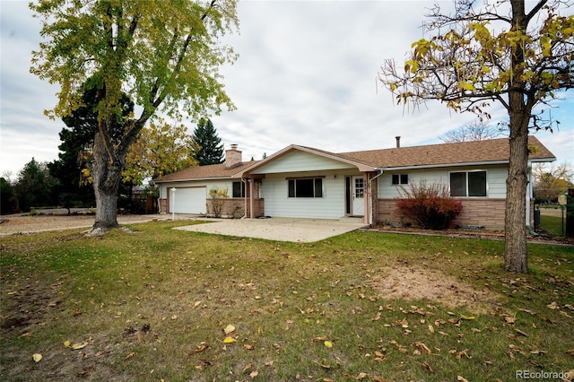 8895 Morton Rd, Niwot, CO 80503 - view of front of home featuring an attached garage, a front lawn, a chimney, and brick siding