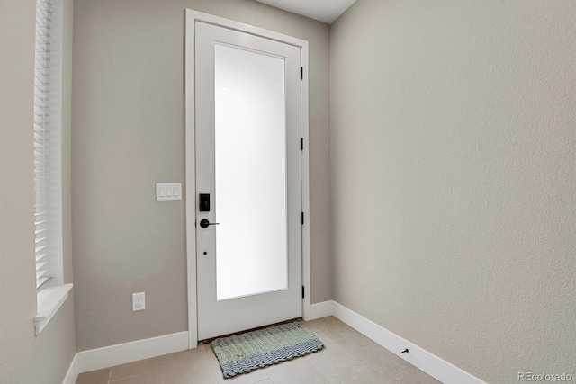 doorway with light tile patterned floors