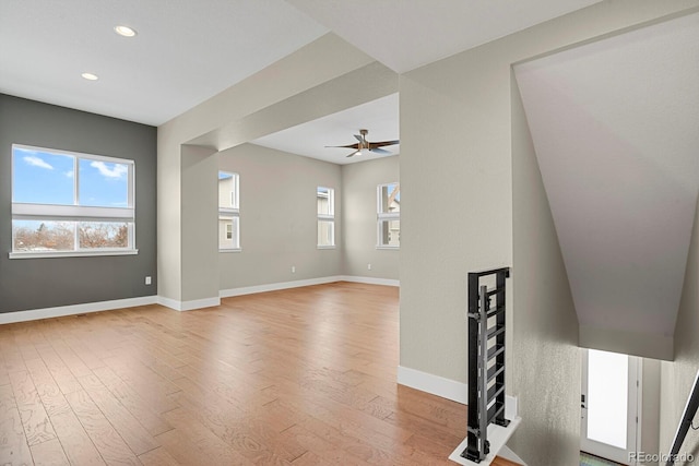 unfurnished living room with hardwood / wood-style floors and ceiling fan