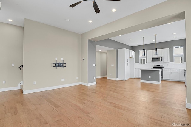 unfurnished living room with ceiling fan and light hardwood / wood-style floors