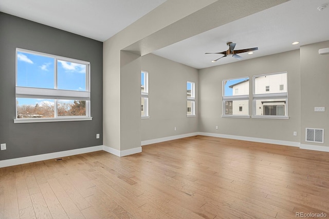 empty room featuring ceiling fan and light hardwood / wood-style flooring