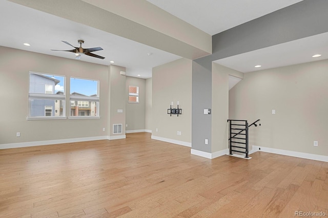 unfurnished living room featuring ceiling fan and light hardwood / wood-style flooring