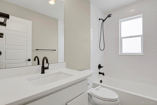 full bathroom featuring vanity, toilet, and tiled shower / bath