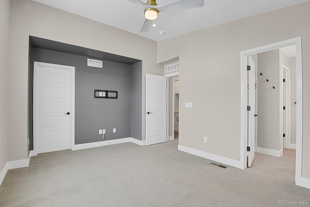 unfurnished bedroom with light colored carpet and ceiling fan