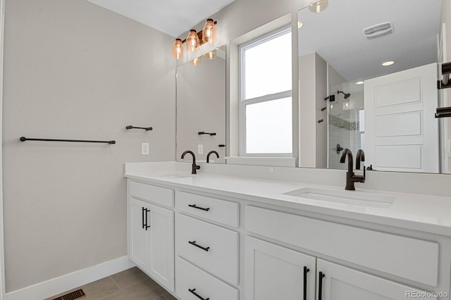 bathroom with vanity, tile patterned flooring, an enclosed shower, and plenty of natural light