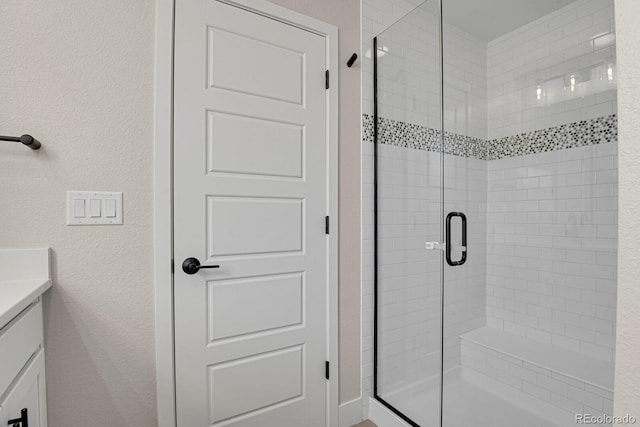 bathroom featuring an enclosed shower and vanity