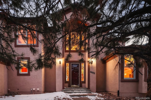 view of snow covered property entrance