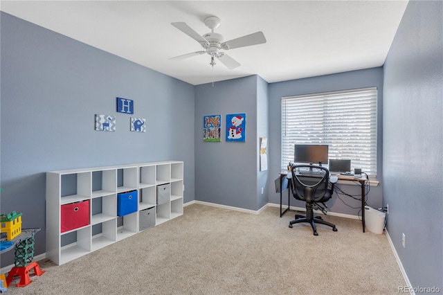 carpeted home office featuring ceiling fan