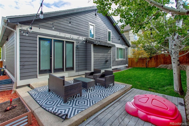 back of property featuring outdoor lounge area, a wooden deck, and a lawn