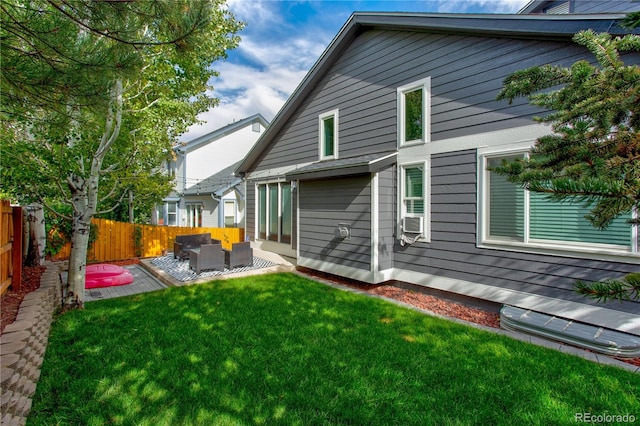 rear view of property featuring outdoor lounge area, a yard, and cooling unit