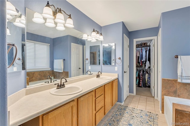 bathroom featuring tile patterned floors, vanity, a relaxing tiled tub, and an inviting chandelier