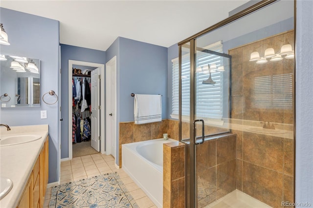 bathroom featuring tile patterned flooring, vanity, and independent shower and bath