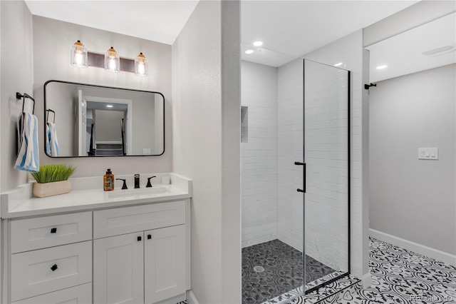 bathroom with tile patterned floors, a shower with door, and vanity