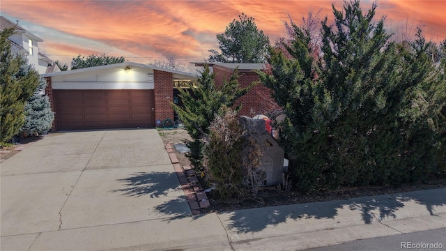 110 Forest St, Denver, CO 80220 - view of front facade with concrete driveway and brick siding