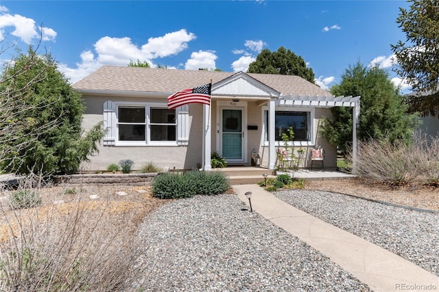 916 E Ln Salle St, Colorado Springs, CO 80907 - view of front of home featuring a pergola, stucco siding, and a shingled roof