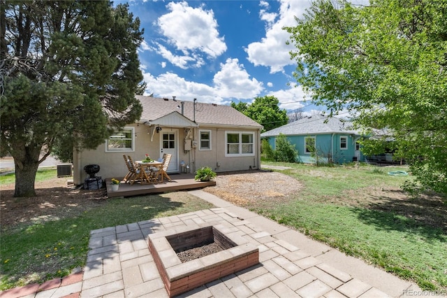916 E Ln Salle St, Colorado Springs, CO 80907 - back of property featuring a fire pit, a wooden deck, a patio, a lawn, and roof with shingles