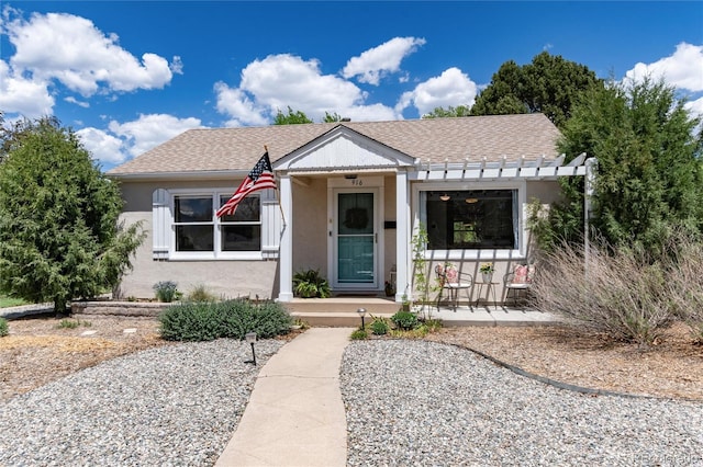916 E Ln Salle St, Colorado Springs, CO 80907 - view of front of home featuring stucco siding, a porch, and roof with shingles