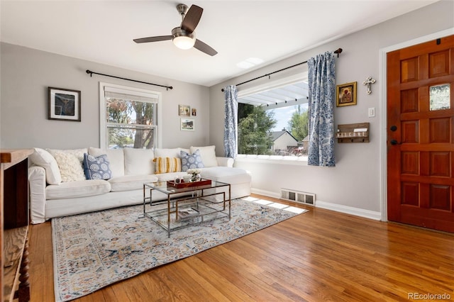 916 E Ln Salle St, Colorado Springs, CO 80907 - living room featuring healthy amount of natural light, wood finished floors, a ceiling fan, and baseboards