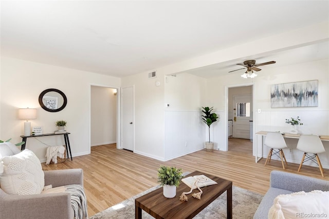 living room with ceiling fan and light wood-type flooring