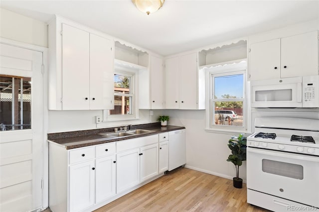 kitchen featuring white appliances, light hardwood / wood-style flooring, white cabinetry, and sink