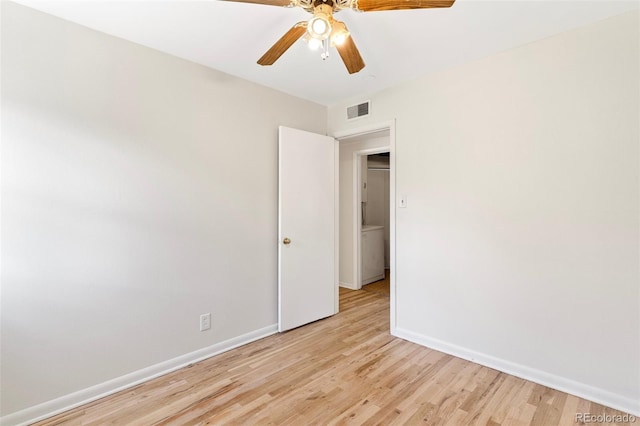 spare room featuring light hardwood / wood-style floors and ceiling fan