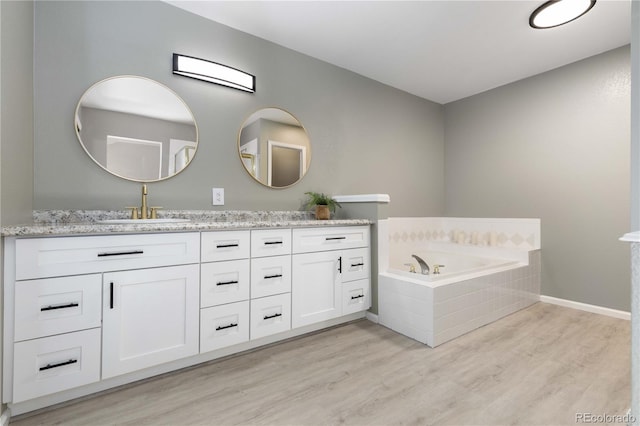 10183 Grove Loop Unit D, Westminster, CO 80031 - full bathroom with double vanity, wood finished floors, and a garden tub