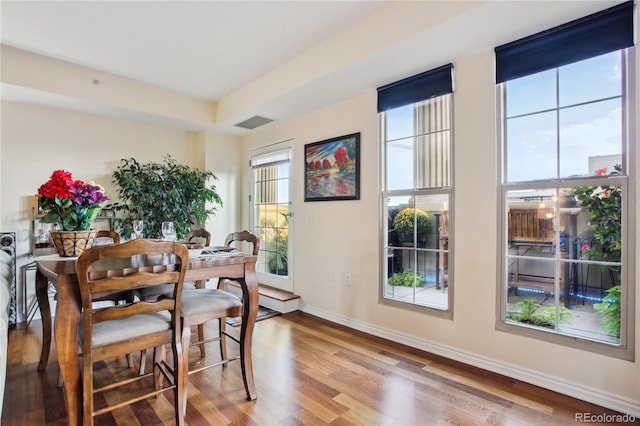 dining space with hardwood / wood-style floors