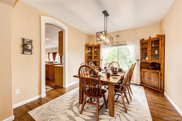 12000 Horseshoe Ln, Parker, CO 80138 - dining area with arched walkways, wood finished floors, and baseboards