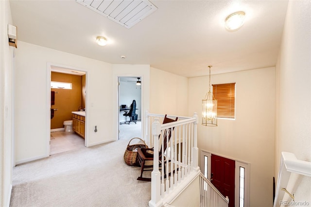 12000 Horseshoe Ln, Parker, CO 80138 - hallway featuring an upstairs landing, light colored carpet, an office area, baseboards, and a chandelier