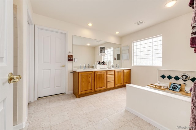 12000 Horseshoe Ln, Parker, CO 80138 - bathroom with double vanity, recessed lighting, baseboards, decorative backsplash, and tile patterned flooring