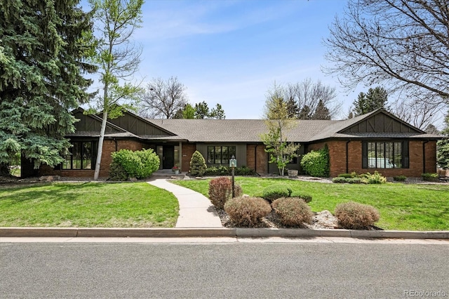 5290 Nassau Cir E, Cherry Hills Village, CO 80113 - view of front of property featuring a front yard, roof with shingles, brick siding, and board and batten siding