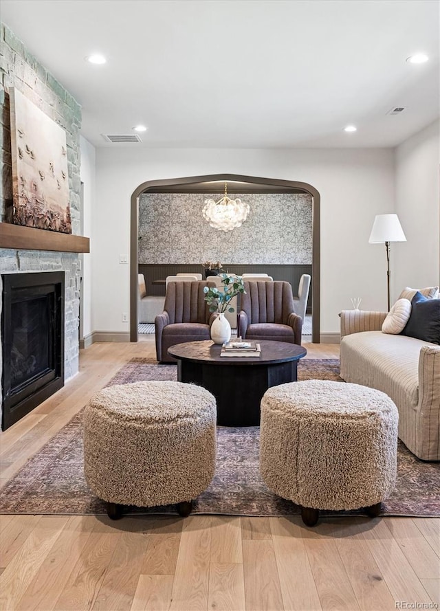 5290 Nassau Cir E, Cherry Hills Village, CO 80113 - living room with arched walkways, a chandelier, visible vents, and wood finished floors