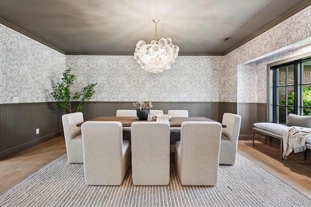 5290 Nassau Cir E, Cherry Hills Village, CO 80113 - dining room with ornamental molding, an inviting chandelier, visible vents, a wainscoted wall, and wood finished floors