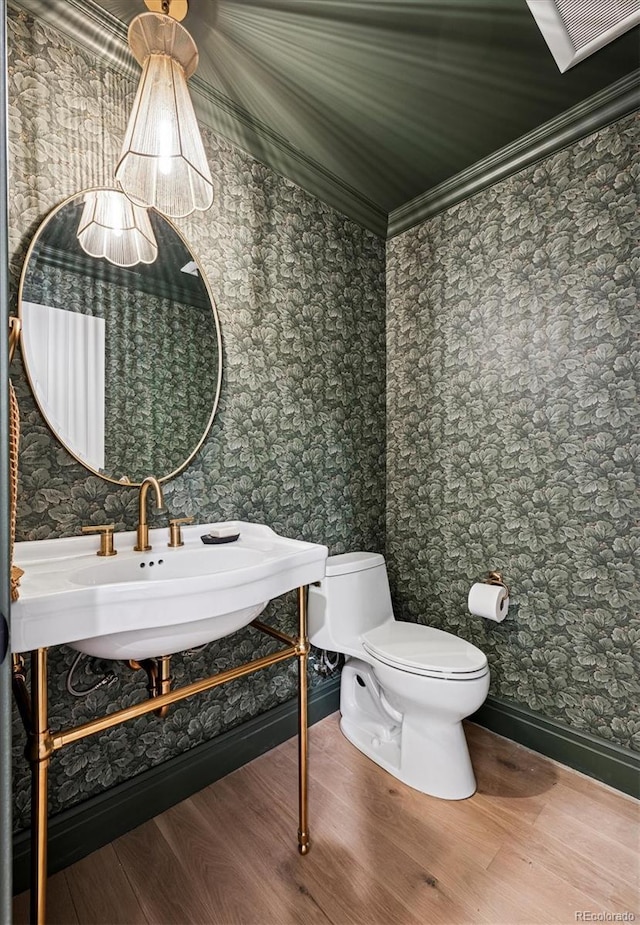 5290 Nassau Cir E, Cherry Hills Village, CO 80113 - half bathroom with wallpapered walls, toilet, a sink, crown molding, and wood finished floors