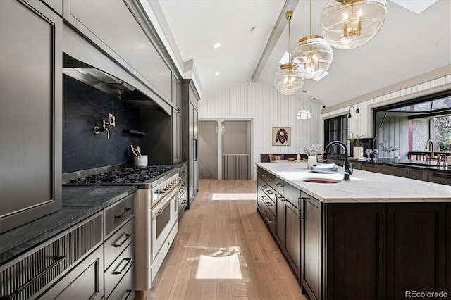 5290 Nassau Cir E, Cherry Hills Village, CO 80113 - kitchen with lofted ceiling with beams, light wood-style flooring, a sink, and stainless steel range
