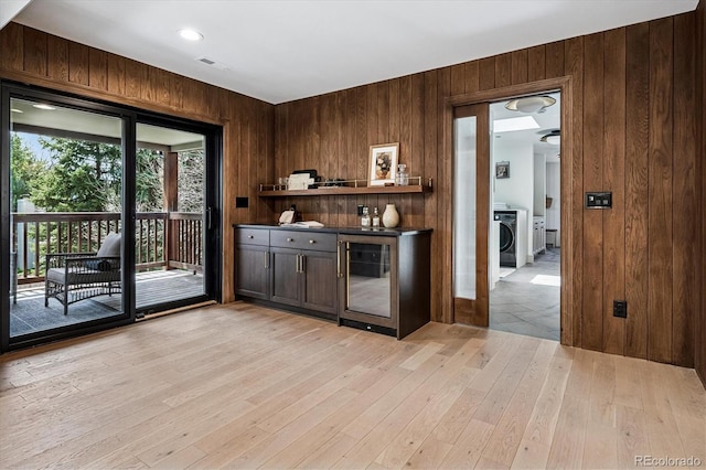 5290 Nassau Cir E, Cherry Hills Village, CO 80113 - bar with washer / clothes dryer, wood walls, visible vents, light wood-style flooring, and beverage cooler