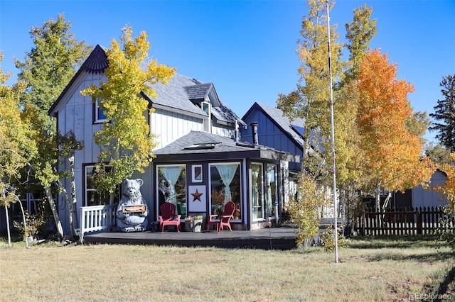 rear view of house featuring a lawn