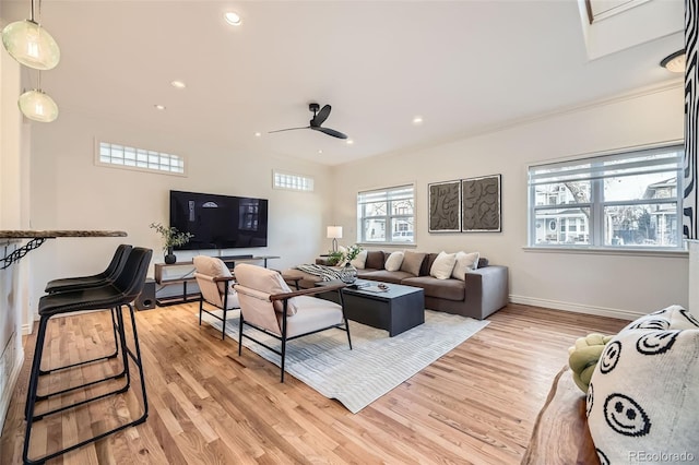 living room with ceiling fan and light hardwood / wood-style flooring