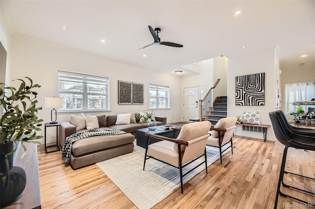 living room featuring crown molding, plenty of natural light, light wood-type flooring, and ceiling fan