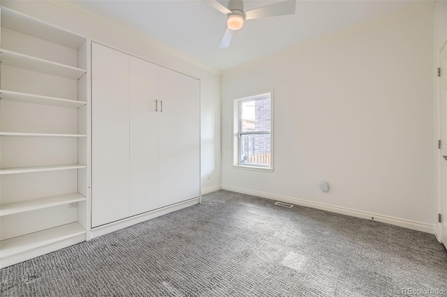 unfurnished bedroom featuring carpet floors and ceiling fan