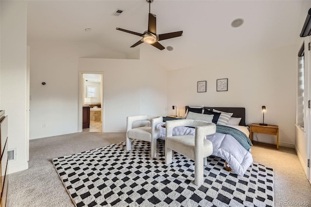 carpeted bedroom with ceiling fan, ensuite bathroom, and vaulted ceiling