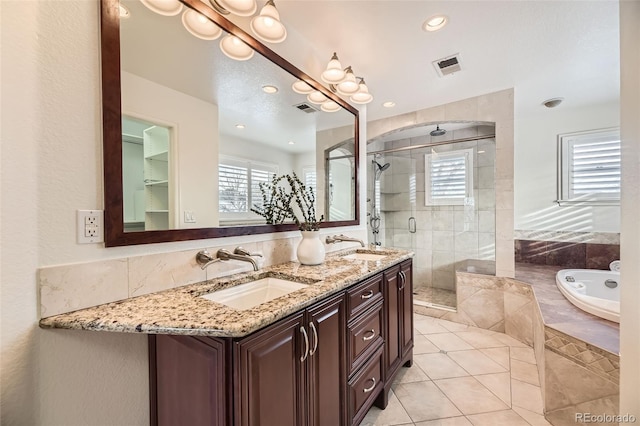 bathroom with tile patterned floors, independent shower and bath, and vanity