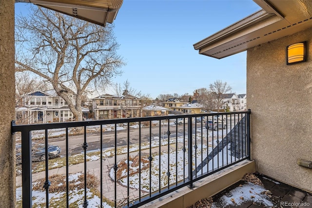 view of snow covered back of property