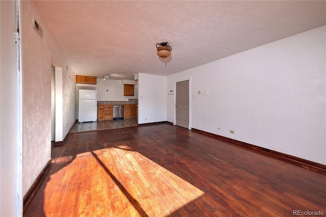 unfurnished living room featuring dark hardwood / wood-style floors