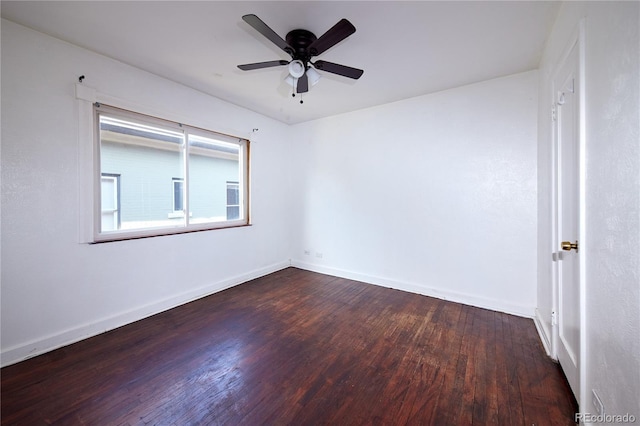 empty room with ceiling fan and dark hardwood / wood-style floors