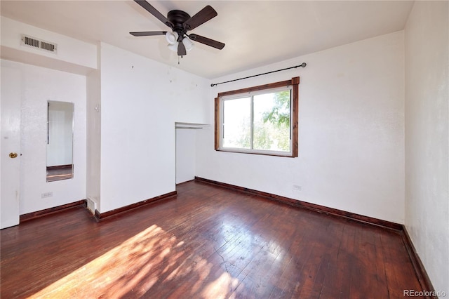 empty room with ceiling fan and dark hardwood / wood-style floors