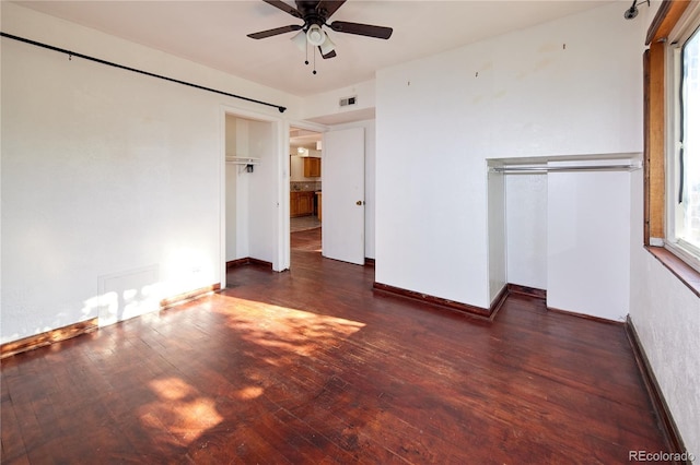 unfurnished bedroom with a closet, ceiling fan, and dark hardwood / wood-style flooring