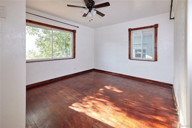 spare room with ceiling fan and dark hardwood / wood-style flooring